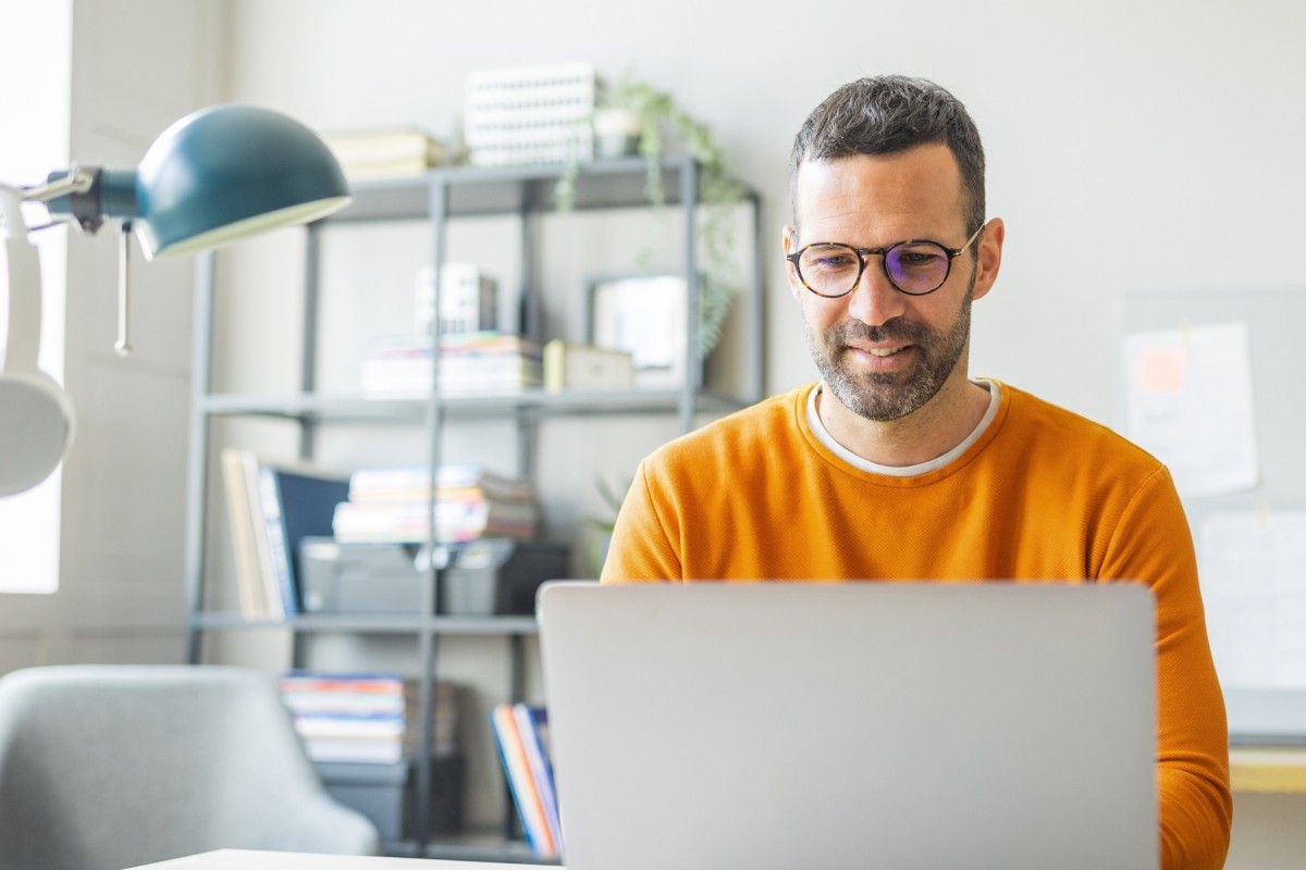 An employee completing online trainings on a laptop.